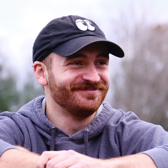 Photo of a bearded man in a black baseball cap